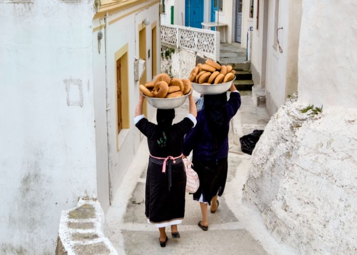 Greek grandmas carrying freshly-baked bread in Karpathos - credits: Hector Christian/Shutterstock.com