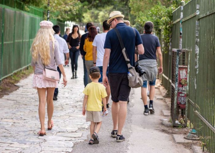 Family walking on Athens&#039; streets towards the Acropolis- credits: Page Light Studios/Shutterstock.com